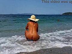 Mature woman with stretched nipple piercings and multiple pussy piercings on the beach