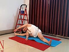 A woman in white underwear practices yoga in the gym