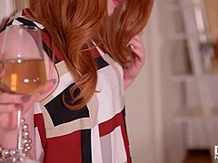 Ella Hughes, a sensual redhead, pleasures herself with a crystal dildo in explicit video
